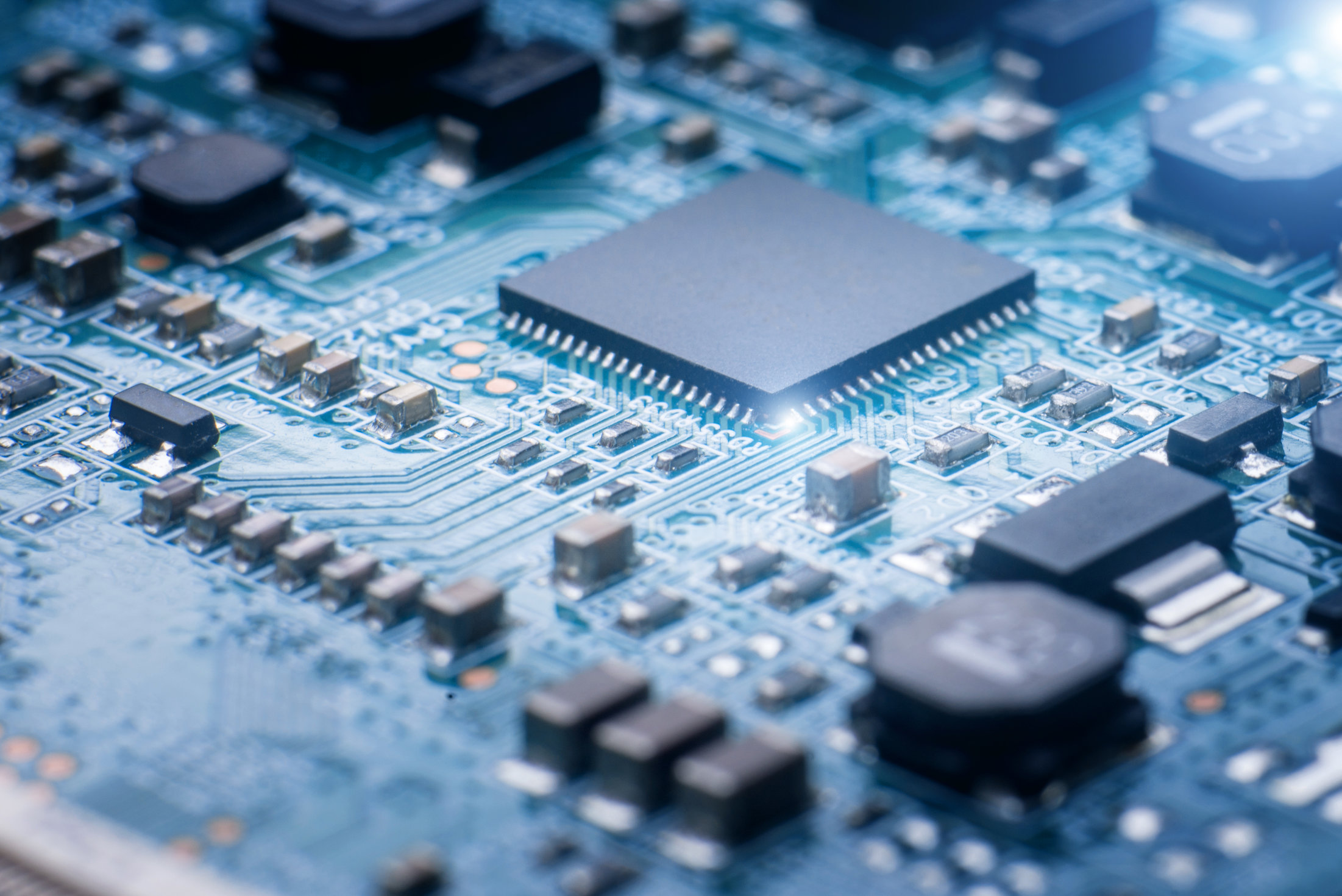 Abstract close-up on the Microchip on blue circuit board